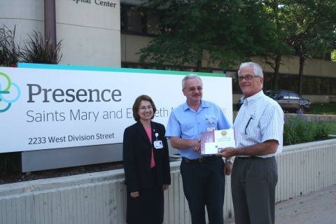 Zinoviy Gunyak (center) is the 2013 recipient of the Hygiene Specialist Excellence award sponsored by UMF Corporation. Gunyak is a member of the Environmental Services Team at Presence Saints Mary and Elizabeth Medical Center, Chicago. He is pictured with the hospital's ES Director Maria Roman, REH, who nominated him for the award, and UMF Corporation CEO George Clarke. (Photo: Business Wire)