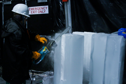 Mr. Qiu Guanghui, captain of the VYA Ice Carving Team from Harbin, China uses a chainsaw to cut into the first block of at ICE LAND Ice Sculptures at Moody Gardens. The team will carve 900 tons of ice to create the Gulf Coast's first ice sculpture attraction opening Nov. 15 on Galveston, Island. (Photo: Business Wire)