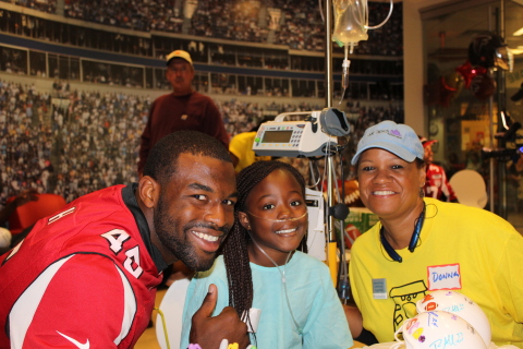 Atlanta Falcon Jacques Smith with a UnitedHealth Group volunteer and patient from Children's Healthcare of Atlanta, at today's Project Sunshine party (Photo: Project Sunshine).