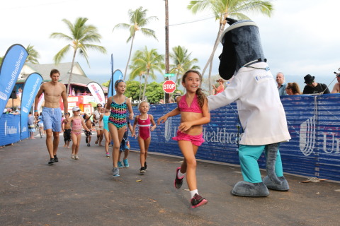 Kylie Morones from Kama'aina Kids smiles as she crosses the finish line, becoming an "IRONKID" at the UnitedHealthcare IRONKIDS Keiki Dip-n-Dash. Photo Source: Kirk Lee Aeder