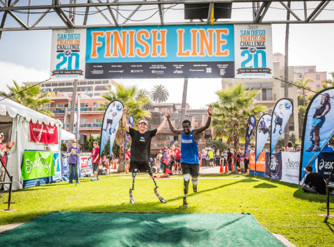 Rudy Garcia-Tolson and Marko Cheseto, two double amputees cross the finish line at the Aspen Medical Products San Diego Triathlon Challenge (Photo: Business Wire)