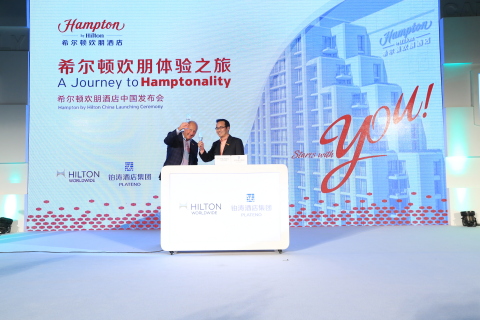 Hilton Worldwide signs an exclusive license agreement with Plateno Hotels Group, one of China's leading hospitality groups, to rapidly launch and develop the Hampton by Hilton brand in China (shown). Phil Cordell, global head of focused service and Hampton brand management, Hilton Worldwide (left) and Eric Wu, CFO of Plateno Hotels Group (right), participate in a ceremonial signing at a launch event in Beijing on October 30, 2014. (Photo: Hilton Worldwide)