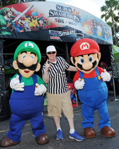 In this photo provided by Nintendo of America, Mario and Luigi visit Florida State University and University of Miami fans to showcase Super Smash Bros. for Wii U outside Sun Life Stadium in Miami, Florida. The latest installment of the Super Smash Bros. franchise, which lets players compete against friends by choosing from an extensive lineup of iconic video game characters, will debut on the Wii U system on Nov. 21, 2014.