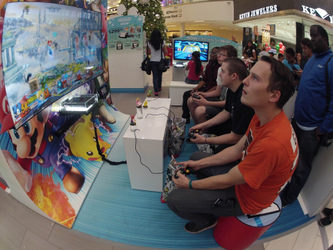 In this photo provided by Nintendo of America, Jacob O., 24, of Philadelphia (R), competes against other consumers playing Super Smash Bros. for Wii U at the Westfield Culver City mall in Los Angeles on Nov. 24, 2014. Until Dec. 21, 2014 in 16 malls nationwide, many of Nintendo’s games will be playable in fun, interactive spaces that kids – and kids-at-heart – will love, including large high-definition displays that will host a Mario Kart 8 and Super Smash Bros. for Wii U. Visitors can also check out the recently released Pokémon Omega Ruby and Pokémon Alpha Sapphire as well as amiibo, Nintendo’s new toys-to-life figures based on its favorite video game characters including Mario, Donkey Kong and Pikachu. (Photo by Nintendo/Bob Riha, Jr.)