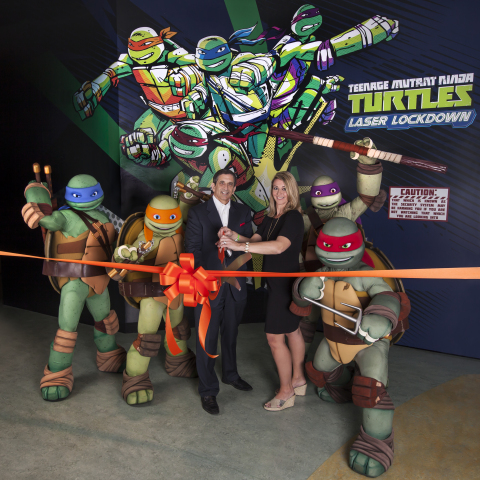 Official Ribbon Cutting to open Teenage Mutant Ninja Turtles Laser Lockdown at the Nickelodeon Suites Resort in Orlando. Louis Robbins from Nickelodeon Suites Resort and Kate Magnusson from  SimEx-Iwerks Entertainment. (Photo: Business Wire)