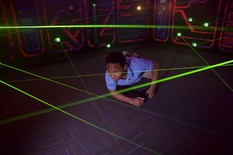 Guests use their ninja stealth skills to navigate a web of high-tech lasers during the interactive experience. (Photo: Business Wire)