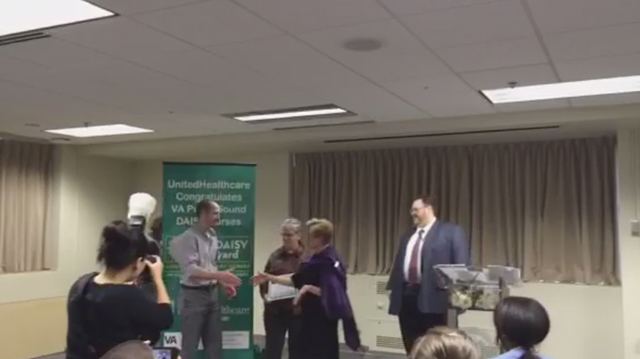 Barb Hostetler, RN, Director of Regional Clinical Services, Northwest Region, UnitedHealthcare Military & Veterans presents, The DAISY Award to Joseph Smith, RN, at a special ceremony today at VA Puget Sound Health Care System in Seattle. Looking on are Melissa Barnes, vice president, The DAISY Foundation; Sean Longosky, Acting Deputy Director and Karen Allen, Associate Director of Nursing Services, VA Puget Sound Health Care System (Video: Anita Sen).