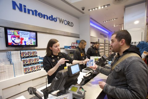 In this photo provided by Nintendo of America, Victor M. of New York, NY, is the first consumer to purchase Pokémon Alpha Sapphire for Nintendo 3DS at the launch celebration at Nintendo World in New York on Nov. 20, 2014. Pokémon Omega Ruby and Pokémon Alpha Sapphire launched in the U.S. on Nov. 21, 2014.