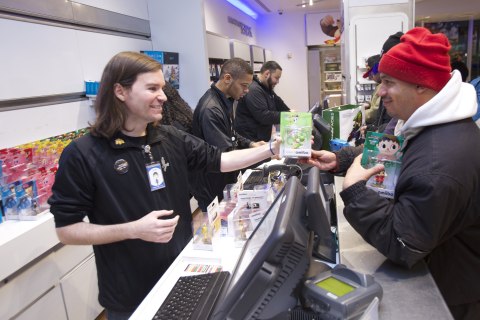 In this photo provided by Nintendo of America, Jose G. of Brooklyn, NY, is the first consumer to purchase amiibo figures at the launch celebration at Nintendo World in New York on Nov. 20, 2014. The figures launched in the U.S. on Nov. 21, 2014.