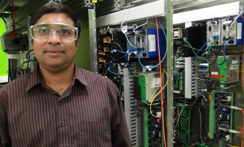 GE researcher Sumit Bose standing in front of the Real Time Digital Simulator used to test renewable and energy storage plant control software. (Photo: Business Wire)