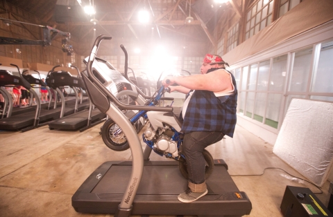 Christian Busath, star of many YouTube videos, rides a mini motorcycle on a NordicTrack Incline Trainer. See it at the iFit booth #74321 in the Sands Expo Center. (Photo: Business Wire)