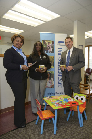 Athens Neighborhood Health Center East COO Cshanyse Allen and CEO Mellinda Craig, and UnitedHealthcare employee Michael Hathcock set up a new Sesame Street reading corner at the Athens Neighborhood Center East. This is one of 14 reading corners being donated as part of UnitedHealthcare's Healthy Habits for Life partnership with Sesame Workshop (Photo: Windgate Downs).