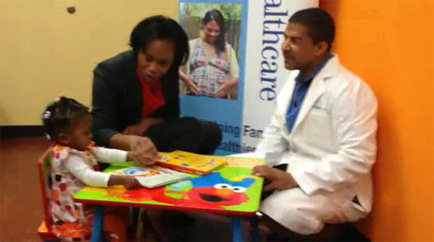 At the Southside Medical Center in Atlanta, 18 month old Dakota Lemons is being read one of the new Sesame Street books by Jocelyn Chisholm Carter of UnitedHealthcare and David Williams, M.D., President and CEO of Southside Medical Center. Dakota is using one of the newly donated Sesame Street reading corners by UnitedHealthcare to 14 Federally Qualified Health Centers (FQHC) throughout the state. The donations are part of UnitedHealthcare's Healthy Habits for Life partnership with Sesame Workshop, which aims to help families with children ages two to eight make choices that set the foundation for lifelong healthy habits (Video: Windgate Downs).