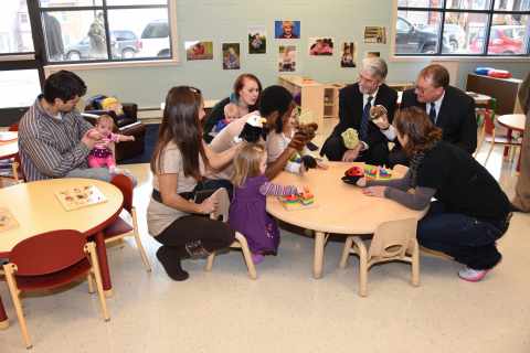 Warren Hanson, executive director, Greater Minnesota Housing Fund (upper left) and John Miklausich, site director, UnitedHealthcare of Duluth (upper right) lead a puppet show with young children and their parents in the new childcare center at Steve O'Neil Apartments during an open house and ribbon cutting event. The new 44-unit permanent supportive housing community and emergency family shelter was made possible through the support of many partners, including UnitedHealth Group, which employs 1,300 people in the region and invested $10.5 million to help build the new apartment community. Photo: Michael K. Anderson