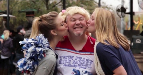 A Dallas man dresses as a cheerleader to earn $250 as part of the new video series promoting the DISH Challenge. (Photo: Business Wire)