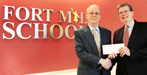 Fort Mill School District Superintendent Dr. Chuck Epps receives a check from STEM Development Foundation Executive Director Dr. Ed Duffy. (Photo: Business Wire)