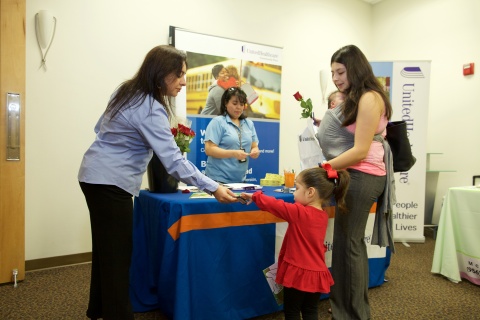 (Left-Right) Carolina Cantu and Yzelda Rodriguez with UnitedHealthcare Community Plan share important information with new mom Karla Solis and her three-year old daughter Scarlett Valentine Solis of McAllen about Baby Blocks online, an interactive incentive program that helps moms receive better pre- and postnatal care. (Photo Credit: Johnny Q. Photography)