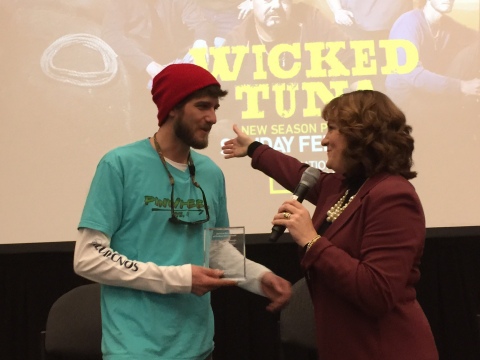 National Geographic Channel Wicked Tuna Captain Tyler McLaughlin receives the American Red Cross First Responder Award from Board Member DawnMarie Corneau at the Wicked Tuna premiere screening at the New England Boat Show in Boston, MA.