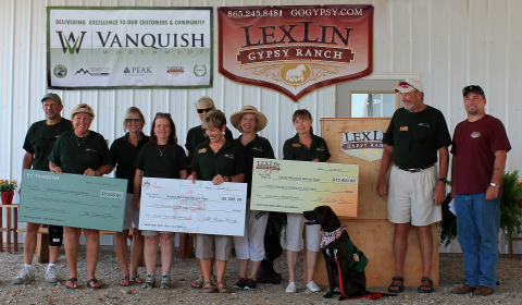 Eric W. Barton presenting 2014 donations to Smoky Mountain Service Dogs board members and volunteers on behalf of Vanquish Worldwide, LexLin Ranch & the Barton family. (Photo: Business Wire)