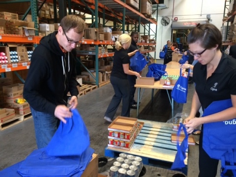 Cigna volunteers stuff backpacks with healthy food for students at Thew Elementary in Tempe. All 670 students at the school will receive backpacks on Thursday, March 5. (Photo: Business Wire)