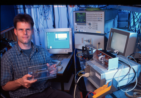 Bert Offrein, manager of the photonics group at IBM Research - Zurich holds an example of silicon photonic chips integrated with an array of polymer waveguides. Credit: IBM Research

