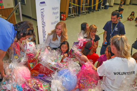 Abigail Pham, 7, received an Easter basket from UnitedHealthcare volunteers and Cypress City Council member Stacy Berry. More than 700 Easter baskets were assembled and delivered to families and kids at the Boys & Girls Club of Cypress, the San Clemente Military Family Outreach and Olive Crest in Bellflower. This is the tenth year that UnitedHealthcare employees at its Cypress, Santa Ana and Irvine offices have come together to donate, assemble and decorate the baskets (Photo: Jamie Rector).