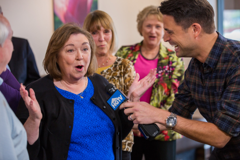 HGTV host, John Gidding, surprises Katherine O'Dell, winner of the HGTV Dream Home 2015, in Huntsville, Alabama, on Friday, March 20. The grand prize features an approximately 3,200-square-foot residence and all its furnishings on Martha's Vineyard, a new 2015 GMC Acadia Denali and a $250,000 cash prize provided by national mortgage lender Quicken Loans. (Photo: Business Wire)