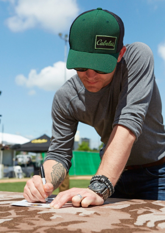 Country singer Justin Moore signs his pledge to put down the technology for a day and get outdoors as part of Cabela's Disconnect Day. Sign your pledge at MyDisconnectDay.com (Photo: Business Wire)

