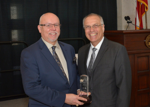 Bruce Fawcett, Executive Director, PolymerOhio presents the Crystal Award for Excellence to Matthew Harthcock of Schneller, LLC. (Photo: Business Wire)
