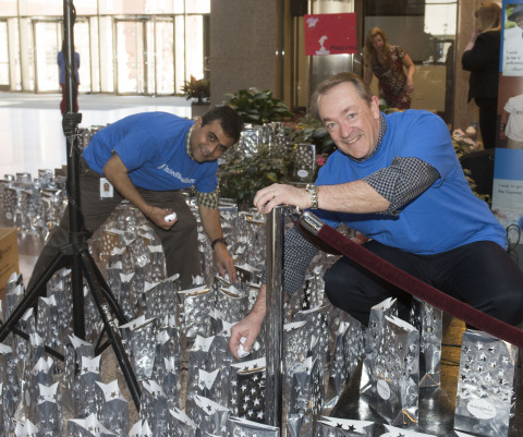 Pritesh Patel (left) and Wayne Zaleski from UnitedHealthcare place the last of the 1,000 luminaires that lit up 185 Asylum St. in recognition of Make-A-Wish's World Wish Day. UnitedHealthcare employees raised more than $16,000 through this state-wide two-week employee "lights of hope" gift campaign to help Make-A-Wish of Connecticut grant wishes to children with life-threatening medical conditions. Today marks the 35th anniversary of the founding of Make-A-Wish. The Connecticut chapter has made more than 2,500 wishes come true since its inception in 1986 (Photo: Digital Creations, Alan Grant).