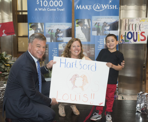 Pam Keough, president and CEO of Make-A-Wish Connecticut and Jim Bedard, CFO of UnitedHealthcare's Northeast Region, present Louis, age 5, with a poster made by UnitedHealthcare commemorating his Make-A-Wish trip to Florida to swim with dolphins. UnitedHealthcare employees raised more than $16,000 through a statewide two-week employee "lights of hope" gift campaign to help Make-A-Wish of Connecticut grant wishes to children with life-threatening medical conditions. Today marks the 35th anniversary of the founding of Make-A-Wish. The Connecticut chapter has made more than 2,500 wishes come true since its inception in 1986 (Photo: Digital Creations, Alan Grant).