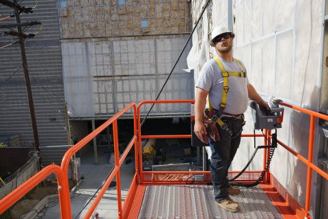 A new lift helped construction crews up to the top of the four-story building to work on windows and siding. (Photo: Business Wire)