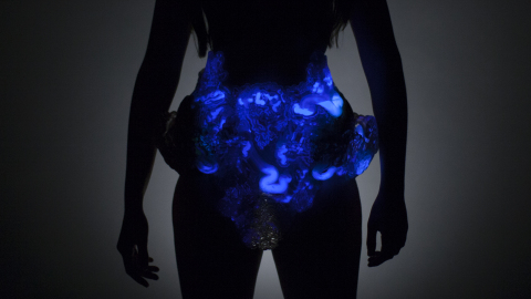 Mushtari filled with luminescent liquid. Neri Oxman reveals the world's first 3D printed photosynthetic wearable, embedded with living matter, produced on the Stratasys Objet500 Connex3 Color Multi-Material 3D Printer. Photo credit: Jonathan Williams and Paula Aguilera, courtesy of Mediated Matter.