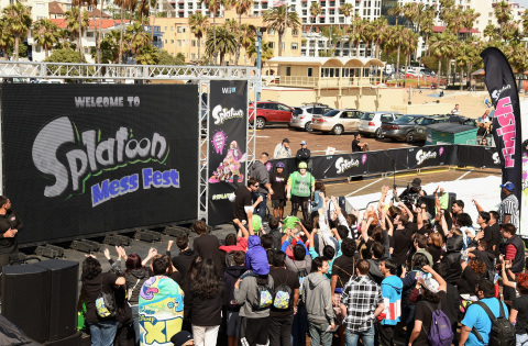 In this photo provided by Nintendo of America, fans gather to cheer on teams as they participate in an ink-filled obstacle course at the Splatoon Mess Fest event at the Santa Monica Pier in California. The event celebrates Splatoon, Nintendo's colorful action shooter game launching exclusively for Wii U on May 29, 2015.