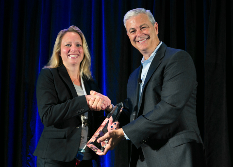 Megan Dooley, deputy trial court administrator for Information & Technology Services at Washtenaw County Trial Court, accepts a Tyler Excellence Award from Bruce Graham, president of Tyler's Courts & Justice Division. (Photo: Business Wire)