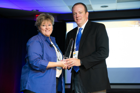 Kim Frisby, Tyler's Appraisal & Tax Division's director of product support, presents a Tyler Excellence Award to Williamson Central Appraisal District Chief Appraiser Alvin Lankford. (Photo: Business Wire)
