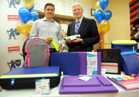 Sasha Barausky, left, Director of Product Management at Staples, and Kirk Saville, right, Vice President, Global Communications at Staples, explore products from Staples' first-ever "Designed by Students" program, which gave students a chance to create and design school products that solve real-life problems, Wednesday, June 3, 2015, at a school in the Brooklyn borough of New York. (Photo by Diane Bondareff/Invision for Staples/AP Images)