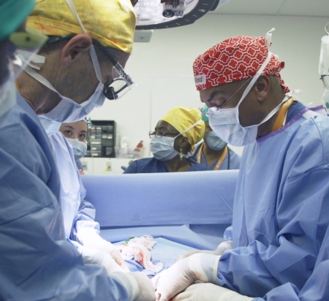 Children's Hospital Los Angeles surgeons James Stein (left) and Henri Ford operate on conjoined twins Marian and Michelle Bernard in Haiti. CHLA sent a team of physicians and nurses to the Caribbean nation to perform the rare separation surgery. (Photo: Business Wire)