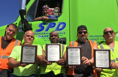 Smokey Point Distributing drivers proudly display the Platinum National Safety Award presented to their company in June by Great West Casualty Company, a leading insurer of trucks and fleets. This is the fifth consecutive year Great West has presented Smokey Point Distributing with its highest-level safety award. Inside truck (top) - Dave Miller. Outside truck (L to R) - Rick Terletter, Doug Larson, Kelly Robertson, Les Robarge and Jimmy Galvin.(Photo: Business Wire)