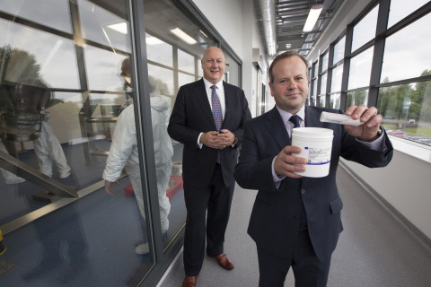 Jim Carswell (right), operations & site leader for Thermo Fisher Scientific's new site in Inchinnan, Scotland, shows off the manufacturer's product: Gibco Advanced Granulation Technology media. The product is an animal-origin free, single-component and particulate-free powder that can reduce the number of components necessary in cell culture manufacturing. Also pictured is Mark Smedley, president & EMEA General Manager for Life Sciences Solutions at Thermo Fisher. (Photo: Business Wire)