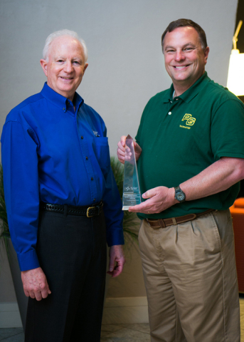 Lee Clarke, senior account executive at Tyler Technologies, presents a Tyler Excellence Award to John Brockwell, director of technology at Prince George County Public Schools, Virginia. (Photo: Business Wire)