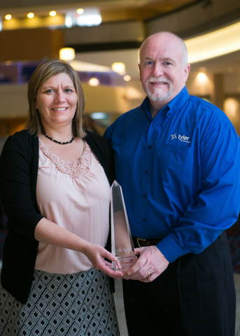 MSD of Lawrence Township, Indiana, Transportation Supervisor Kim Krummel accepts a Tyler Excellence Award from Ted Thien, senior vice president and general manager of Tyler's Versatrans solution. (Photo: Business Wire)