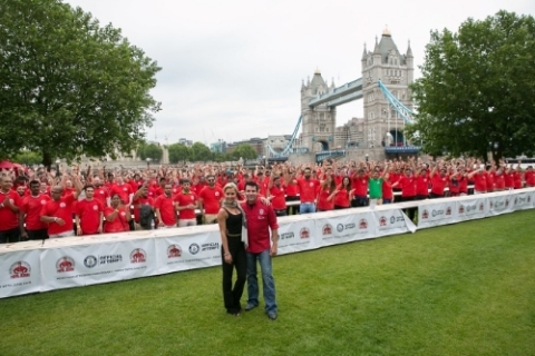 Papa John's Founder, John Schnatter, and Natalie Lowe, star of Strictly Come Dancing, pose for a photo after breaking a GUINNESS WORLD RECORD with 338 people tossing pizza at once. (Photo: Business Wire)