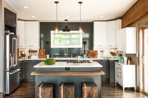 The Blog Cabin kitchen features an island situated to take in the view of the lake just outside. Beautiful stainless steel appliances are ensconced among a mix of white and charcoal cabinetry. The kitchen balances simplicity and clean lines with the livable warmth of natural materials. (Photo: Business Wire)