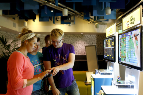 In this photo provided by Nintendo of America, Nina Veress Langenfeld, Benjamin Braun and Kai Seward of Facebook design a level in the Super Mario Maker game during a special "hackathon" event hosted by Nintendo at Facebook HQ in Menlo Park on Wednesday, July 29, 2015. The winning level will be available for Super Mario Maker owners to download and play shortly after the game's launch on the 11th of September. (Photo by Alison Yin/Invision for Nintendo/Facebook/AP Images)
