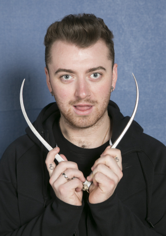 Sam Smith takes some of his own measurements at his Madame Tussauds sitting. (Photo: Business Wire)