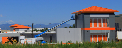 Contractors work to complete Public Storage 10298 E. 45th Ave, Denver, CO 80238 in the Stapleton Business Center, with a view of the Rocky Mountains in the background. The location serves a neighborhood of businesses and new homes. (Photo: Business Wire)