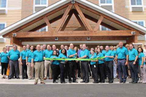 Local officials, WoodSpring Suites associates, and hotel guests gather for the celebratory ribbon-cutting marking the grand opening of WoodSpring Suite's first namesake hotel. (Photo: Business Wire)