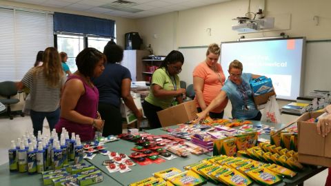 Teachers at Woodland Acres Elementary School, Jacksonville, Fla., select supplies donated by employees of The Main Street America Group to set up their classrooms. (Photo: Business Wire)