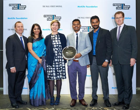 Dennis White (left) and Chris Townsend (right)with representatives from Going to School (Winning Enterprise of Financial Inclusion Challenge - Education Category) (Photo: Business Wire)